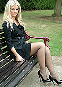 Blonde outdoors in black pantyhose and heels